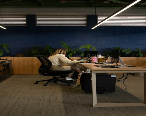 Team of creators working in a modern office space with diffused lateral lighting
